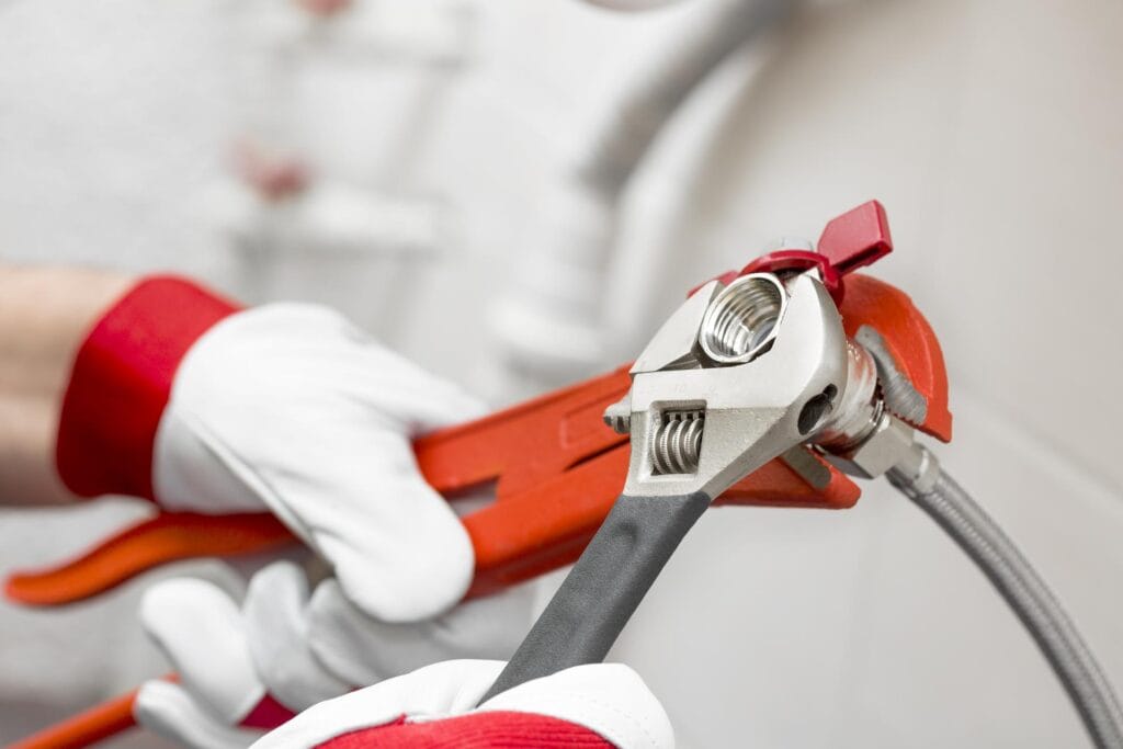 Plumber holding pipe wrenches for an emergency repair in The Villages