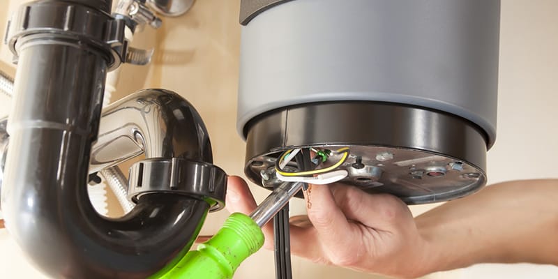 Technician repairing the heating element of a water heater in The Villages