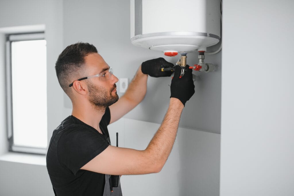 Technician performing water heater maintenance in The Villages