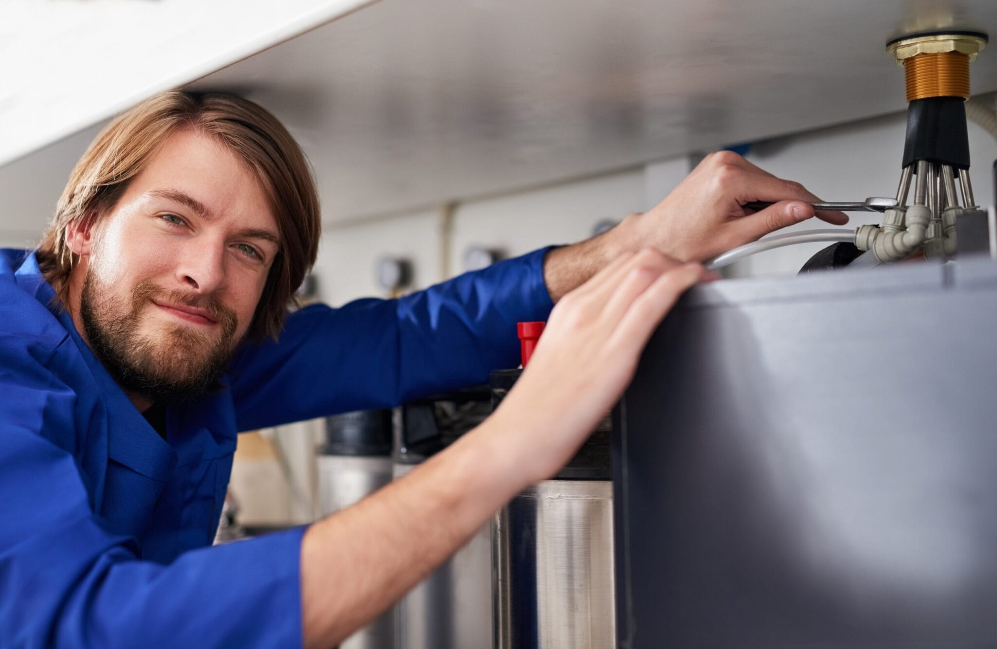 Technician servicing a residential water heater tank in The Villages